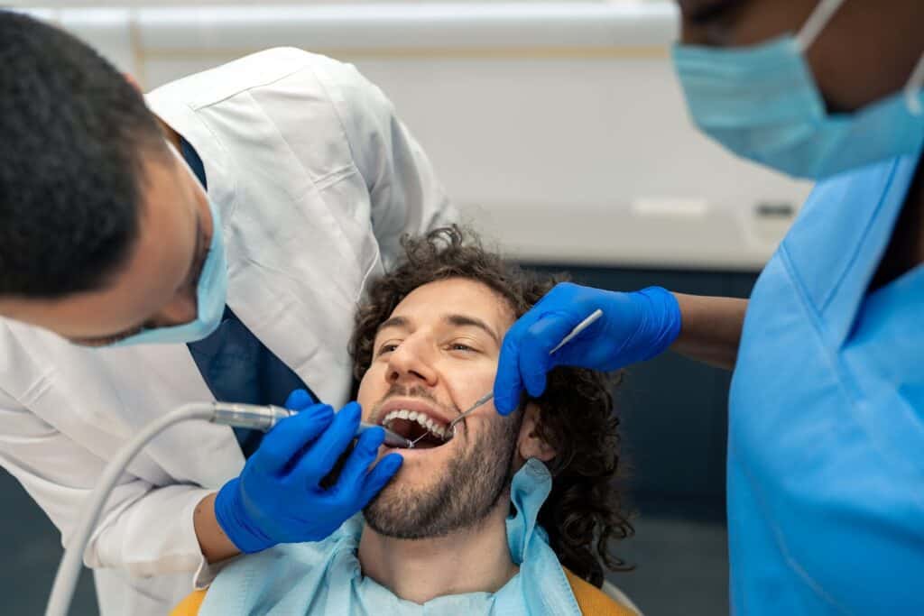 Young Man Having Dental Drill Procedure At Dentist's Office | Smile Virtual