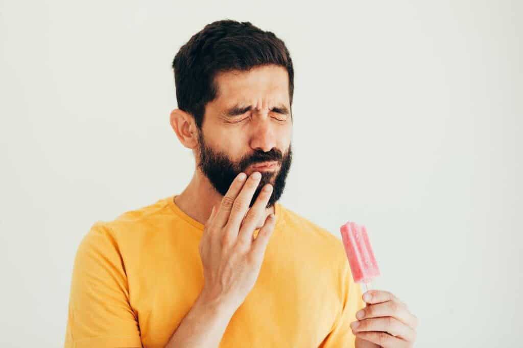Men Holding Strawberry Bar And Pain Sensitivity Started On His Teeth | Smile Virtual