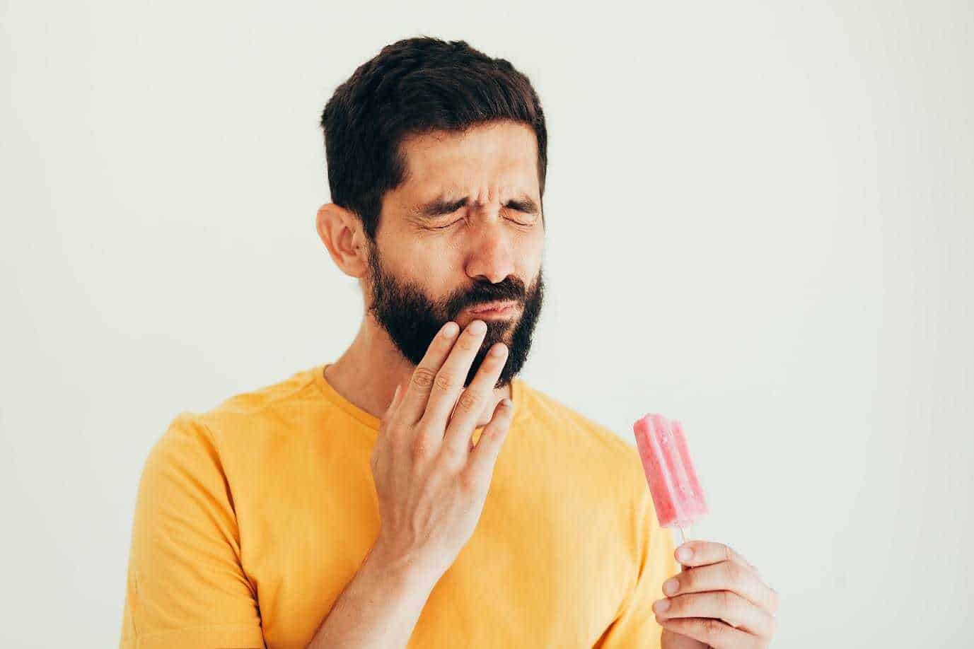 Men Holding Strawberry Bar And Pain Sensitivity Started On His Teeth | Smile Virtual