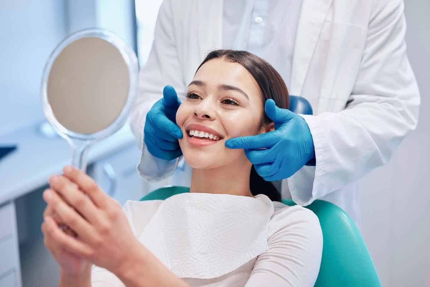 Female Patient Looking Teeth In Mirror At Dental Clinic | Smile Virtual