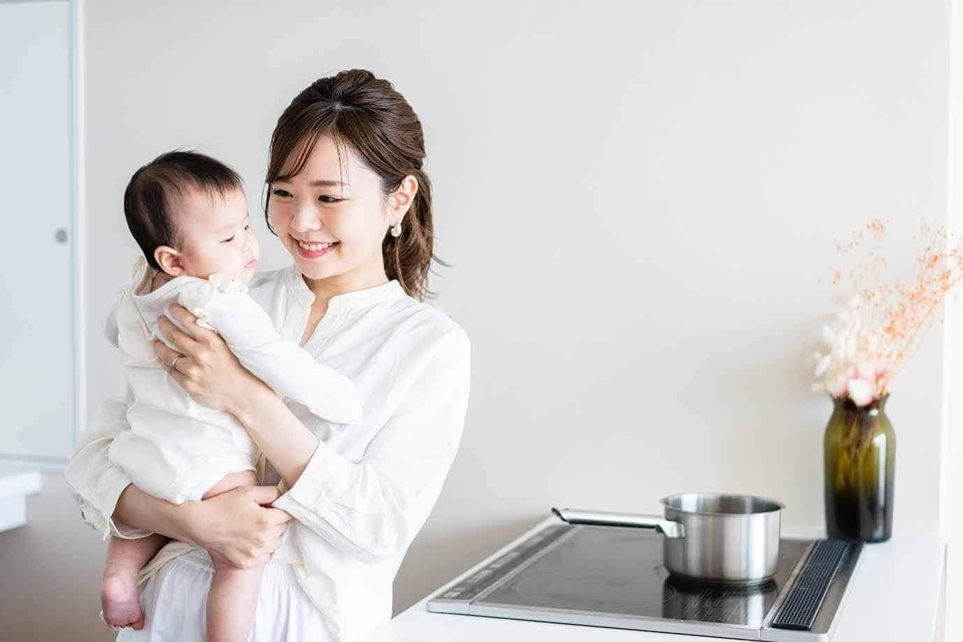 Happy Asian Woman Holding her Baby in Kitchen | Smile Virtual