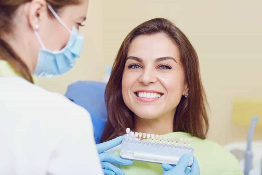 Dentist Holding Veneers Infront of Young Girl | Smile Virtual