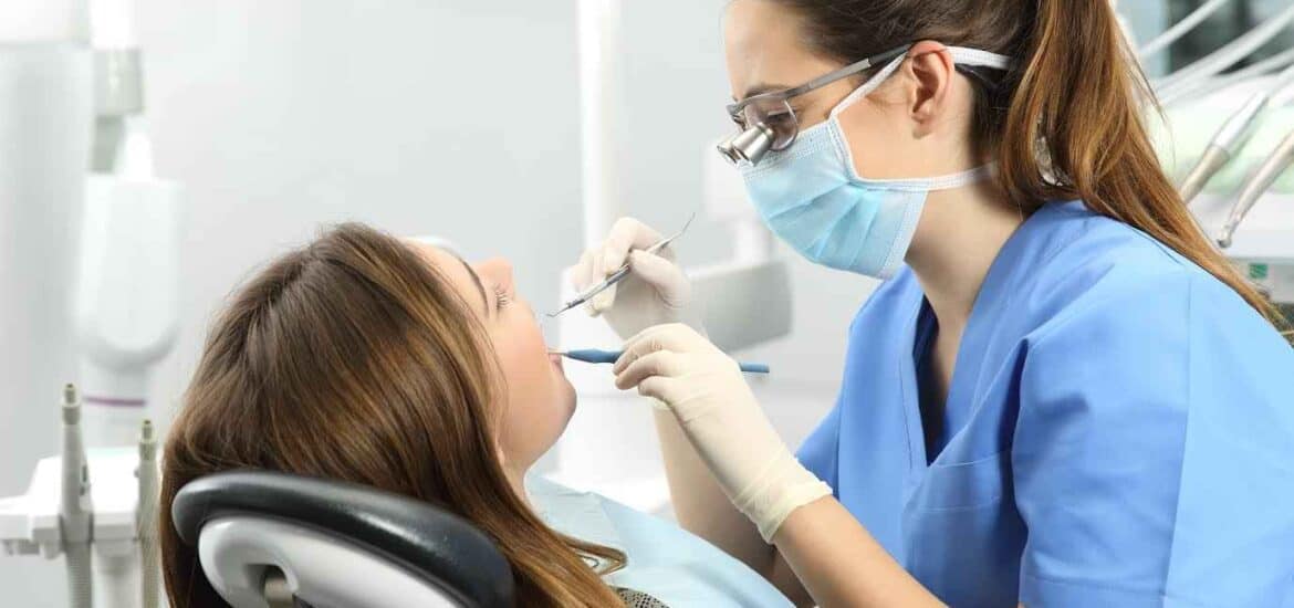 Dentist Wearing Magnifying Glasses and Treating Female Patient | Smile Virtual