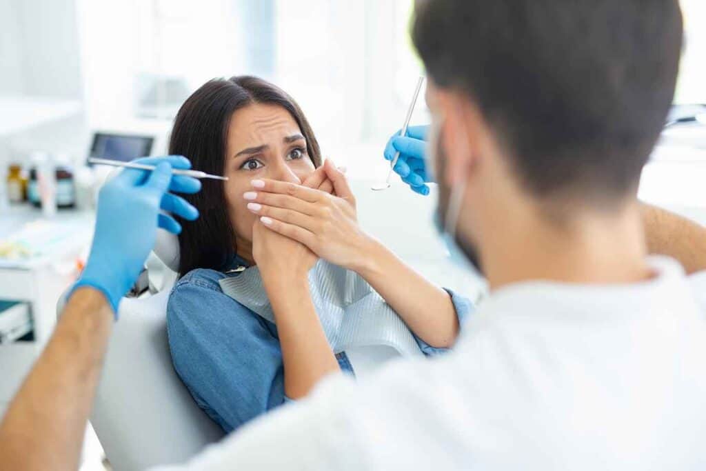 Young Female Cover her Mouth with her Hands & Afraid of Dental Treatment | Smile Virtual