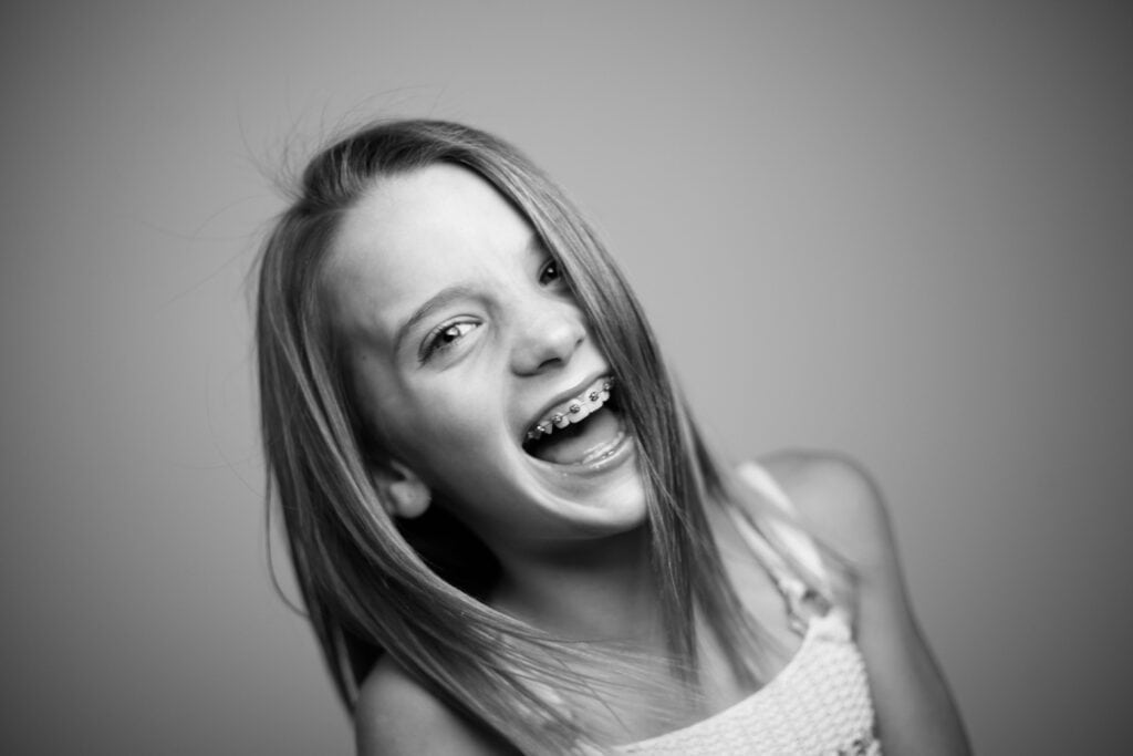 Smiling Girl with Teeth Braces on Black and White Photo | Smile Virtual